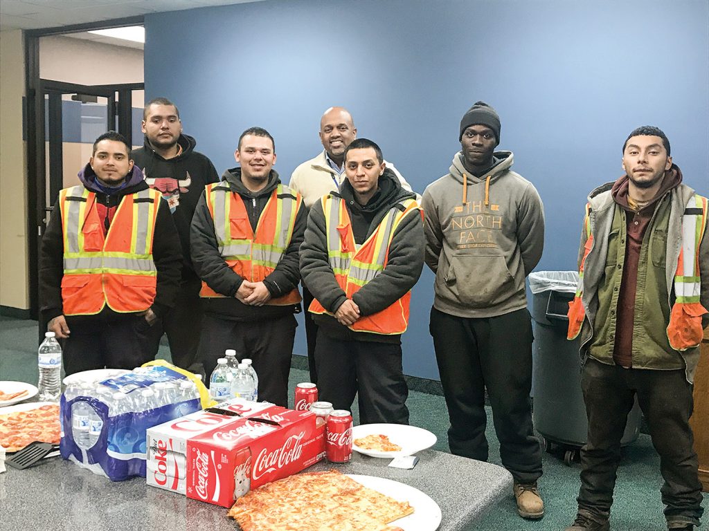 Clayton Harris III, executive director of the Illinois International Port District, pictured here with graduates of Cook County Sheriff Tom Dart’s RENEW program, said the Port of Chicago’s newly launched program to place young, non-violent felons at entry-level jobs in the freight sector is exceeding expectations. As graduates of the program, these young men are realizing their chance at a better life.  (Photo courtesy of the Illinois International Port District) 