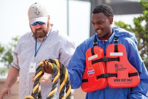 Jerry Berry of Savage Marine works with a student on line-handling.