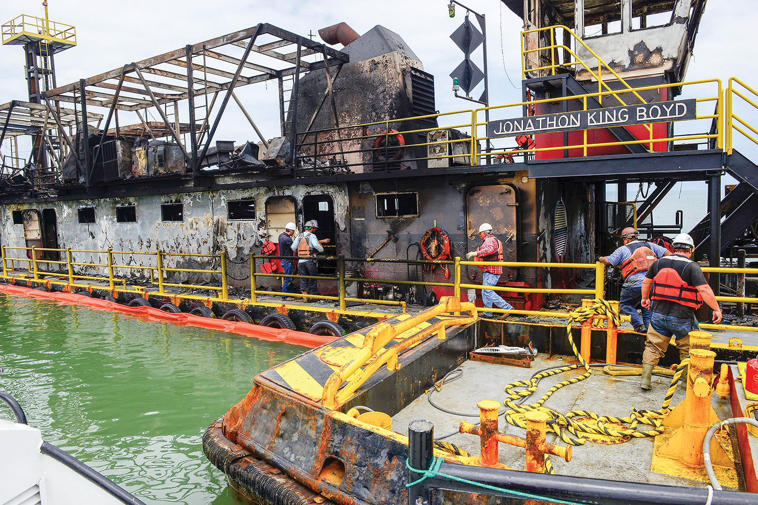 Crews assess damage to burned out dredge Jonathon King Boyd. (U.S. Coast Guard photo by Petty Officer 1st Class Kelly Parker)