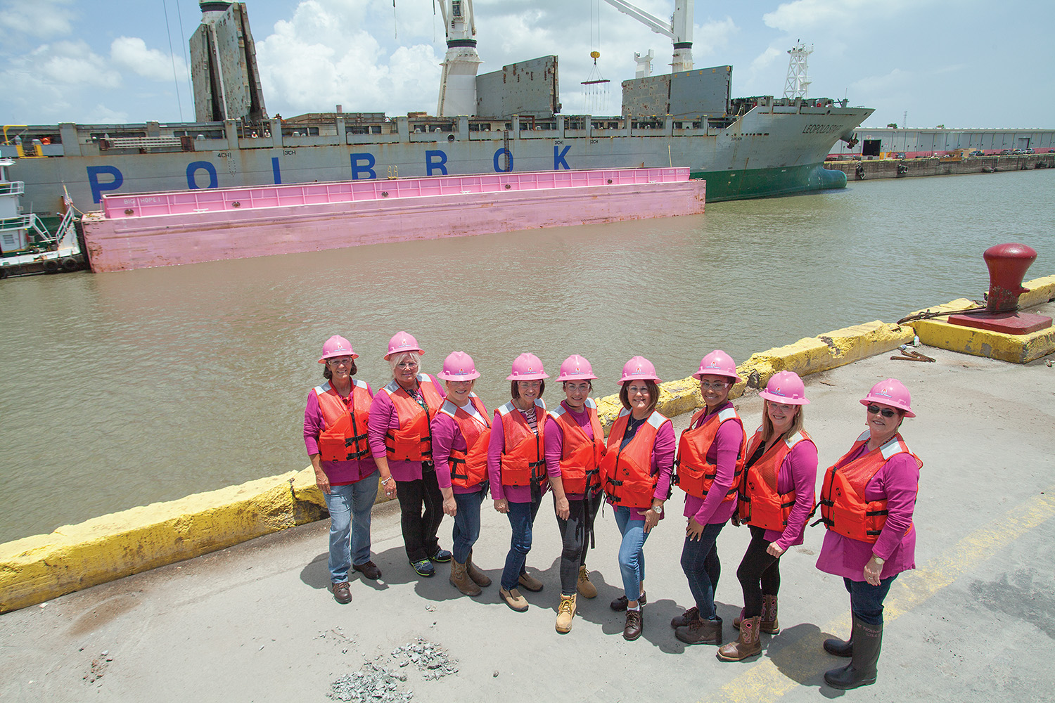 The ladies of Associated Terminals gather for a photo shoot in front of the barge Big Hope 1. (Photo by Frank McCormack)