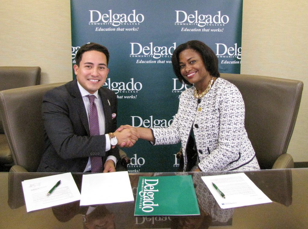 Copa Airlines Sales Executive Ernesto Posados (left) and Delgado Community College Chancellor Joan Davis formalize the new partnership between their organizations to provide students traveling to or from Central and South America and the Caribbean with special airfares.