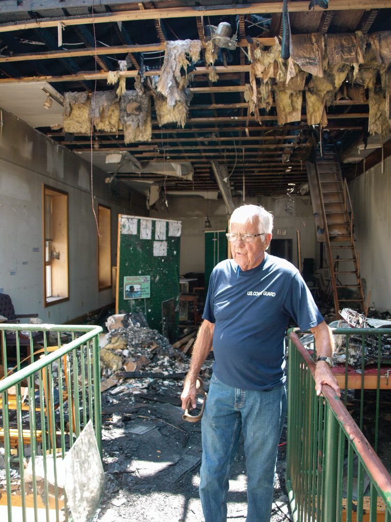 Jack Fowler shows water, ash and fire damage on the museum’s second floor, which housed the museum’s offices, library, towboat pilot simulators and various displays. (Photo by Jim Ross)