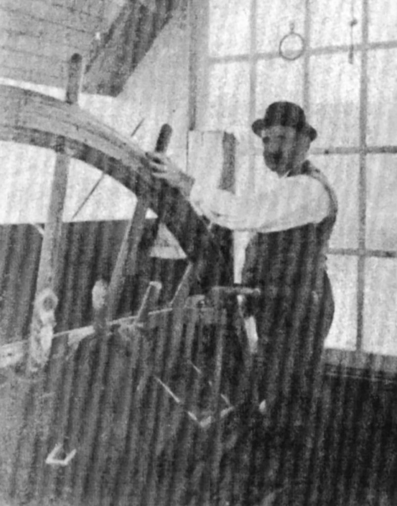 A faded photo of Capt. Ben Stout at the wheel of the Oakland. (Keith Norrington collection)