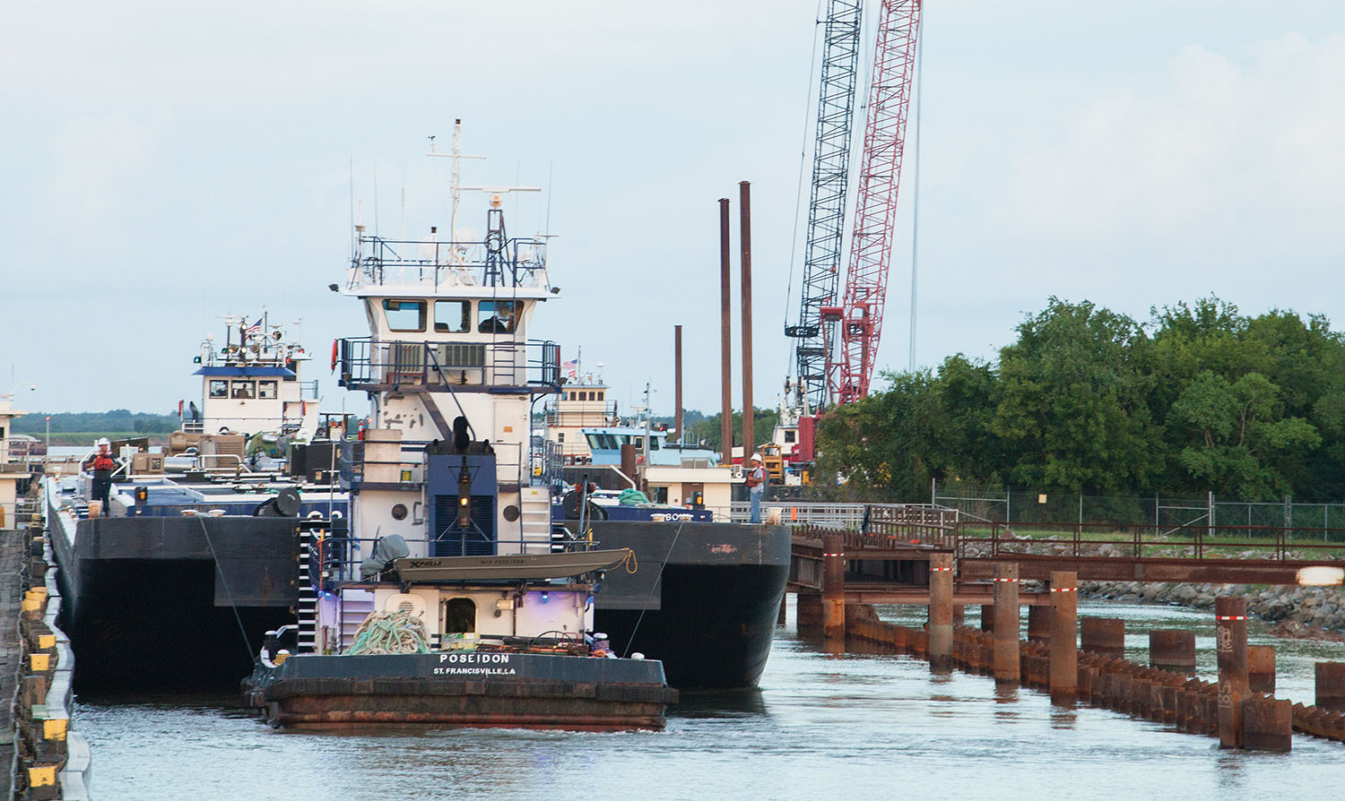 Deloach Marine Services’ mv. Poseidon assists a tow through Calcasieu Lock August 9. The “can opener” is on the right. (Photo by Frank McCormack)