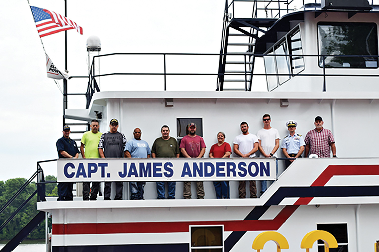 The crew of the mv. Capt. James Anderson celebrates receiving a Certificate of Inspection (COI) from the U.S. Coast Guard. From left to right is Chris Blank with the Coast Guard, Dale Nedrow, Danny Marr, Mike Rogers, Bill Null, Matt Rieger, Juanita Landes, Jonathan Jordan, James Northup, Coast Guard Cmdr. Paul Mangini and Troy Akers. (Photo by Dee Harbrecht)