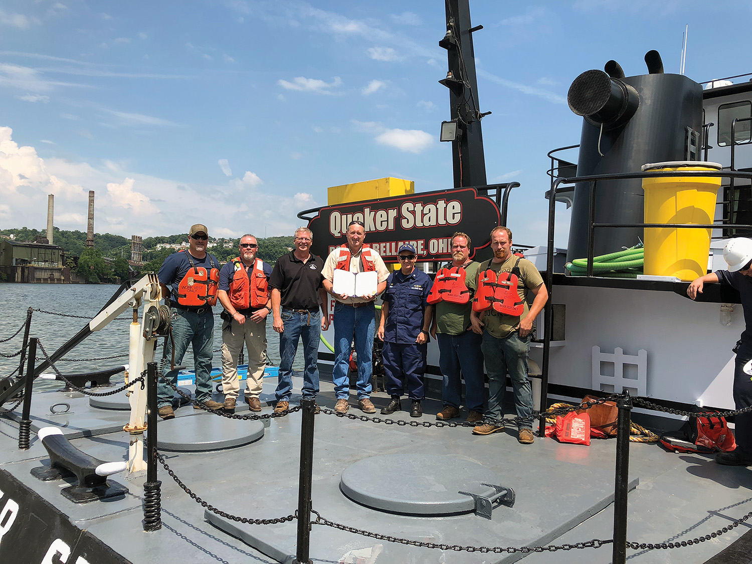 Pictured left to right are Shawn Hodgson, maintenance director; Roger Garretson, EHSS director; Ron Harrison, port captain; Robert Harrison, owner; Aaron Demo, Coast Guard Captain of the Port of Pittsburgh; Jeff Stephen, vessel captain; and Kevin Lyons, deckhand. (Photo courtesy of Bellaire Harbor Service)