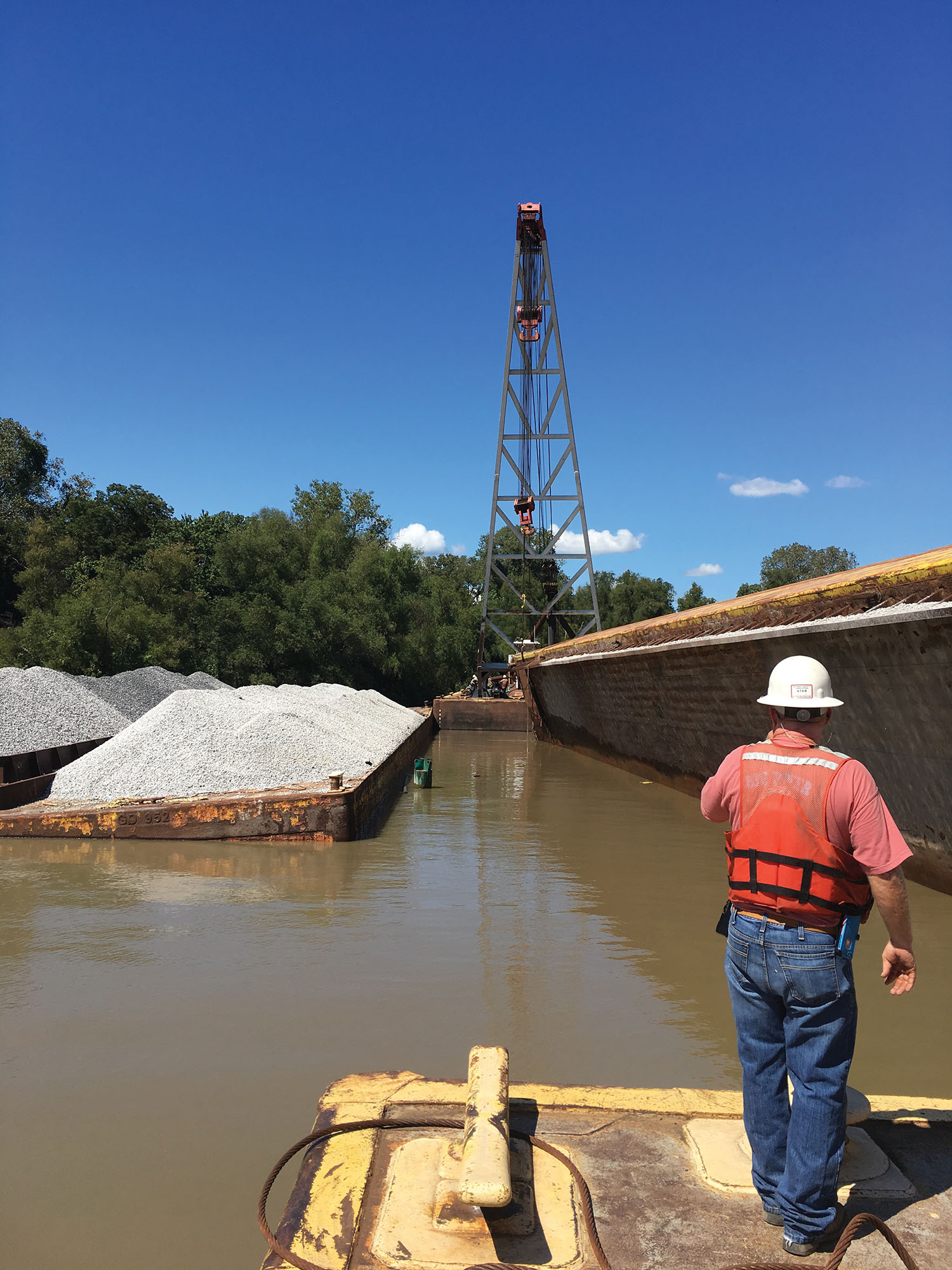 Big River Shipbuilding dispatched a pair of barge-mounted A-frame cranes to the site and successfully flipped the barge and pumped water from its holds on September 16. (Photo courtesy of Big River Shipbuilding Inc.)