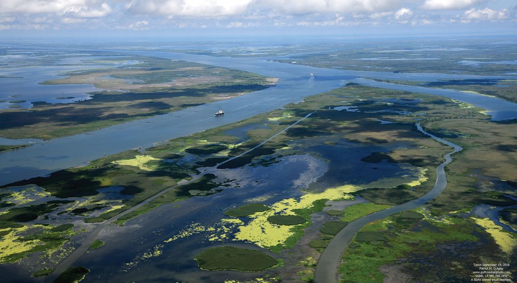 This aerial photo of Southwest Pass taken on September 14, 2018, shows the land that has been created by beneficial use, especially to the west on the left side of the picture. (—Photo by Patrick Quigley, www.gulfcoastairphoto.com )