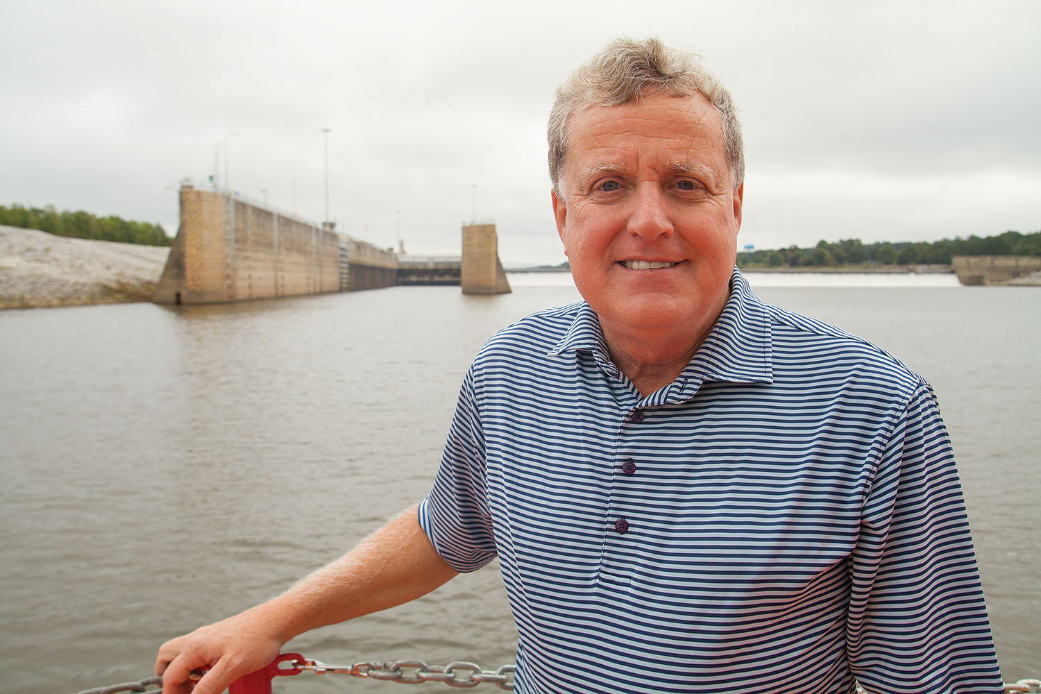 Danny Hensley, retired operations project manager for the Black Warrior-Tombigbee and Alabama-Coosa Waterways, aboard the Corps’ crane barge Choctawhatchee September 28, the day of his retirement. Oliver Lock and Dam on the Black Warrior River is in the background. (Photo by Frank McCormack)