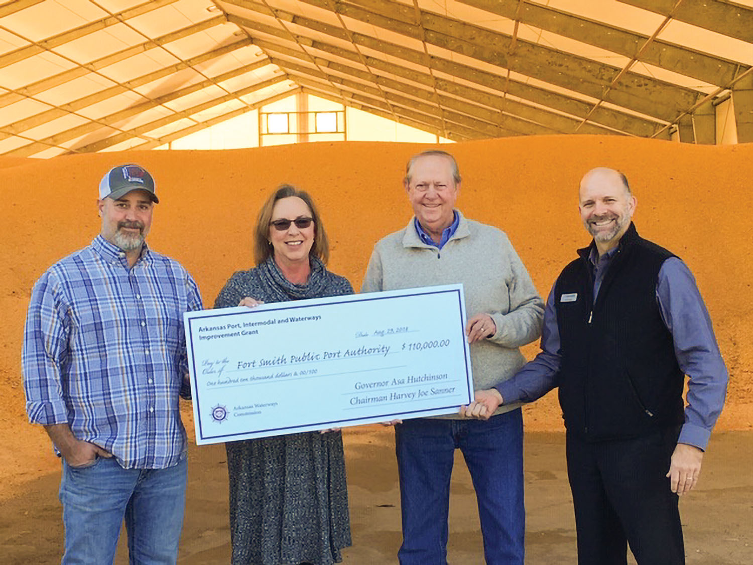 Deidre Smith, director of the Arkansas Waterways Commission, presents ceremonial grant check to Fort Smith Port Authority members Wesley Daniel, Larry Combs and Philip Doss. (Photo courtesy of Five Rivers Distribution)