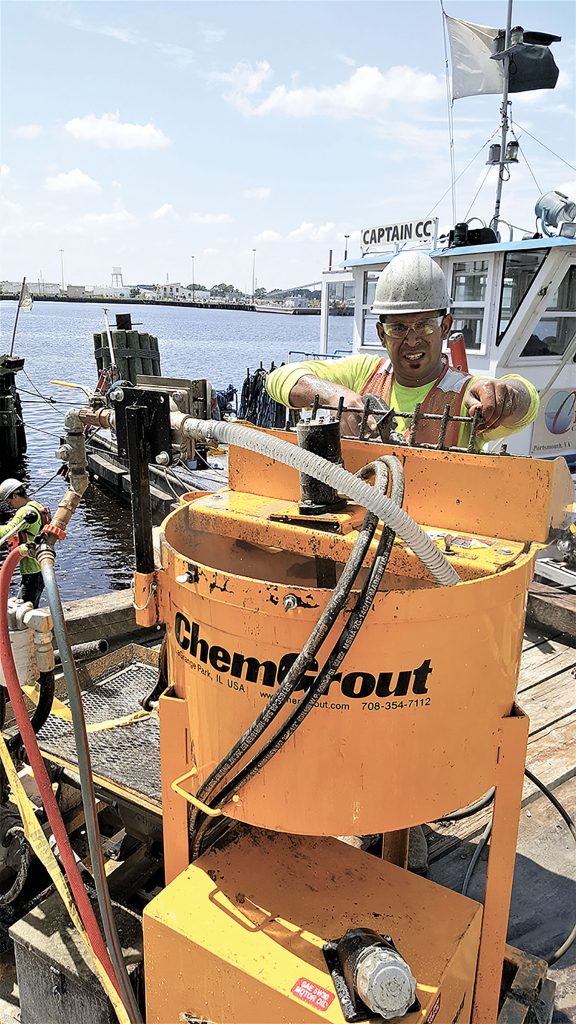 Project Manager Marvin Murphy mixes the grout in preparation for repairing 500 damaged timber piles at an industrial pier in Virginia. (Photo courtesy of FRP Construction/Pilemedic by QuakeWrap