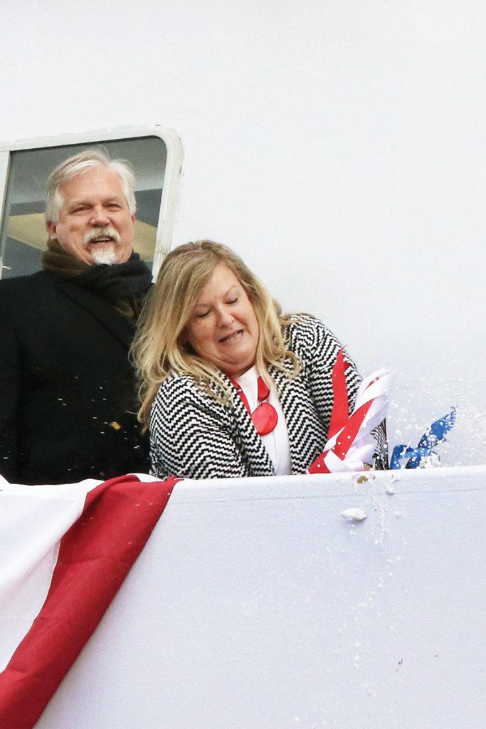 Mary Smith breaks bottle to dedicate vessel named for her husband. (Photo by Jeff L. Yates)
