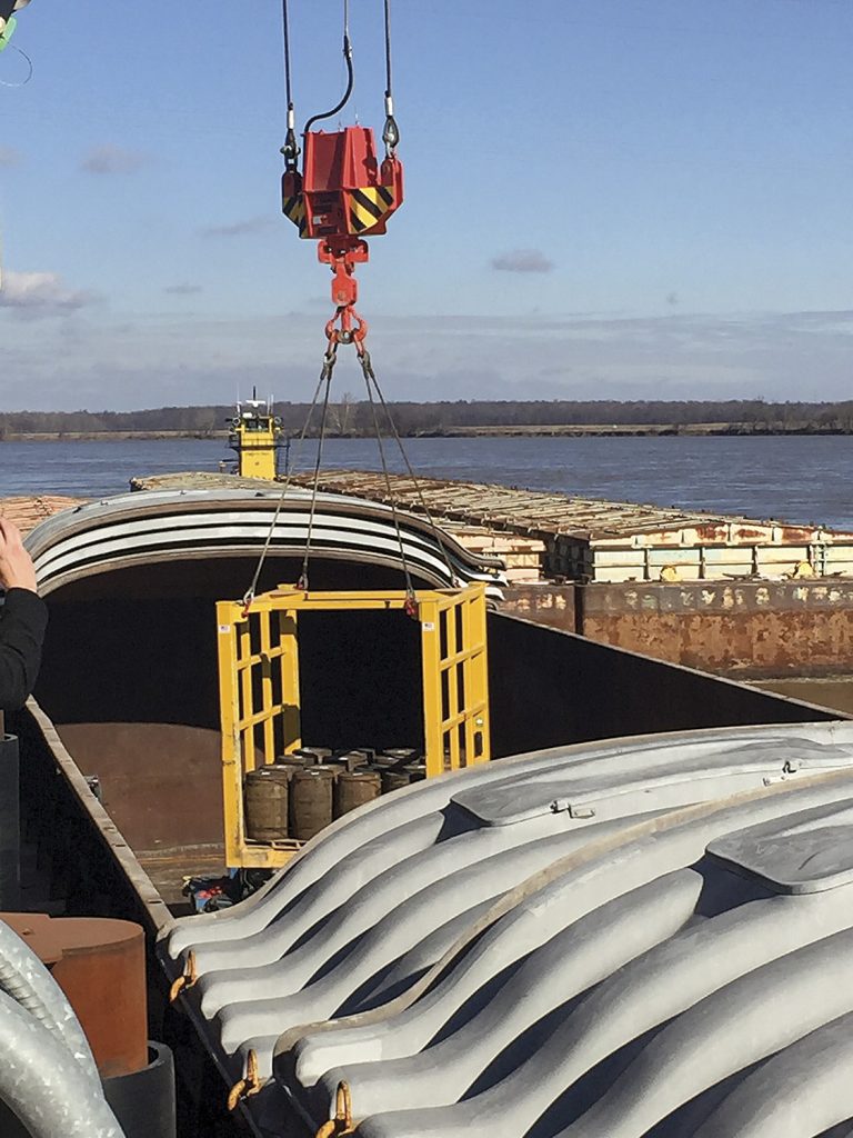 Whiskey barrels are loaded into a hopper barge for trip to New Orleans. (Photo courtesy of Cane Land Distributing Company)