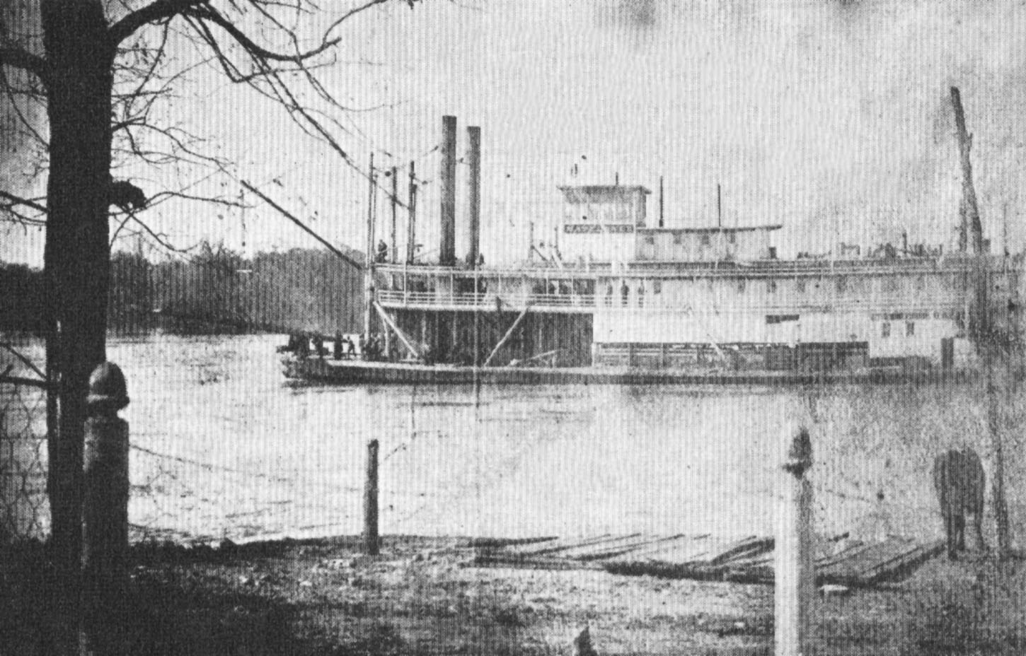 The sternwheeler Mayflower passes Clifton, Tenn., on the Tennessee River, during high water. Note the steamboat acorn finials atop the posts in the foreground. (Keith Norrington collection)