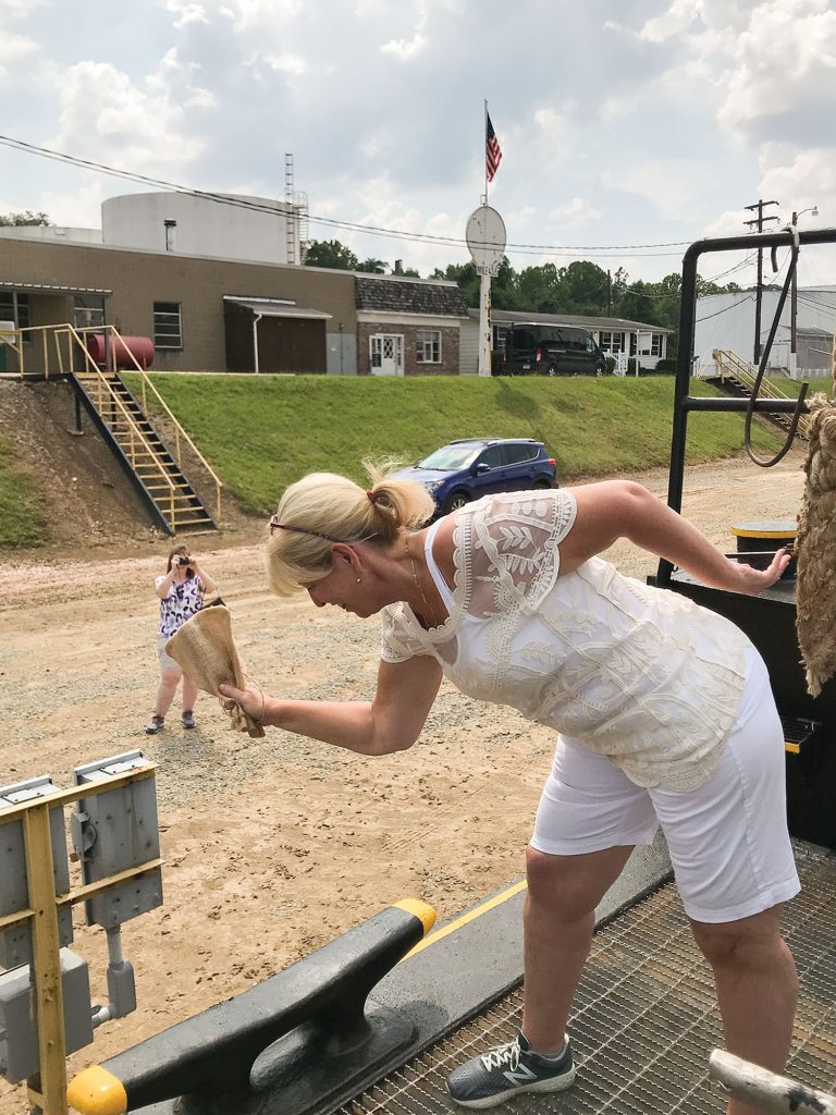 Leslie McGinness breaks the bottle of Guinness to christen the mv. Paul McGinness, named after her late husband. (Photo courtesy of TowLine River Service)