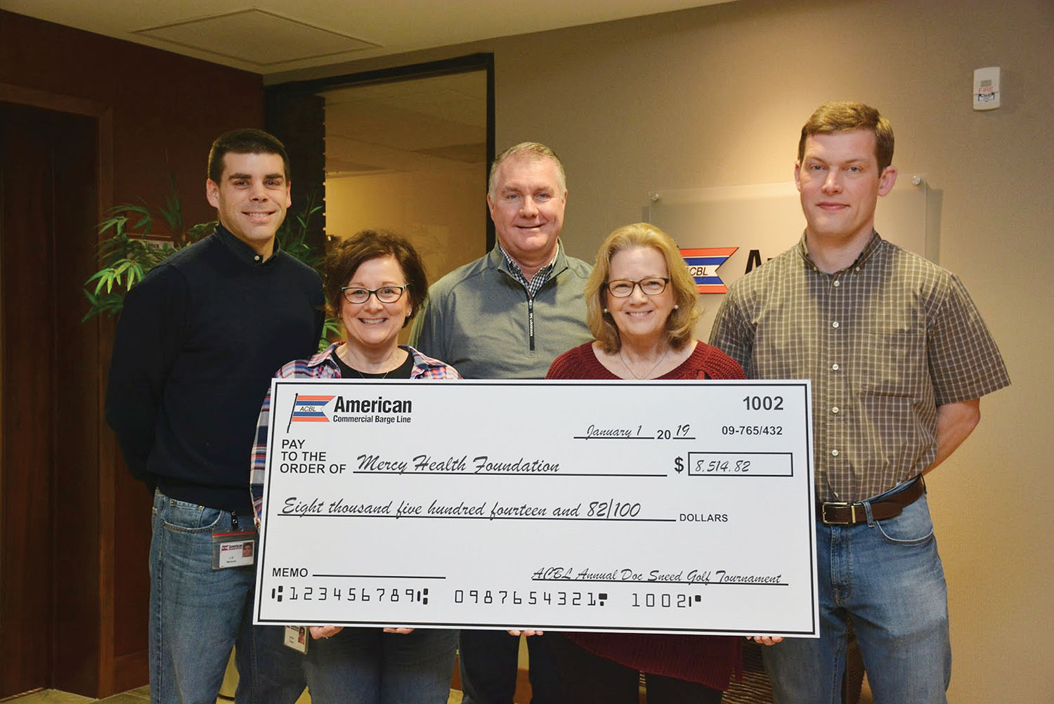 Displaying the proceeds from the 2018 tournament are J.B. Meiman, director logistics boat planning; Jenifer Tretter, administrative assistant; Rich McCarty, director of grain and fertilizer; Kathy Sneed; and Neil Collins, ACBL director of purchasing.