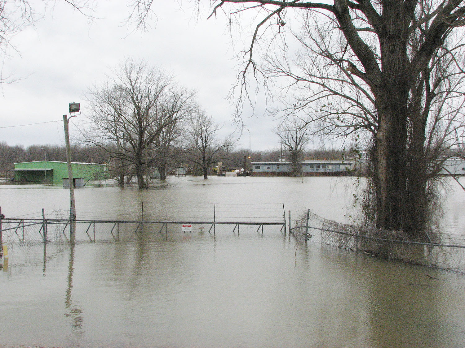 Floodwaters at Greenville, Miss., where Nichols Boat Company normally builds its hulls, are preventing work on a new harbor boat it is building. However, pre-fab construction is able to continue nearby.