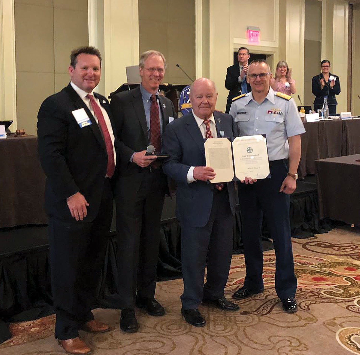 From left, Clark Todd, Blessey Marine Services president and chief operating officer; Scott Merritt, American Waterways Operators chairman; Walter Blessey Jr.; and Rear Adm. John Nadeau, Coast Guard assistant commandant for prevention policy.