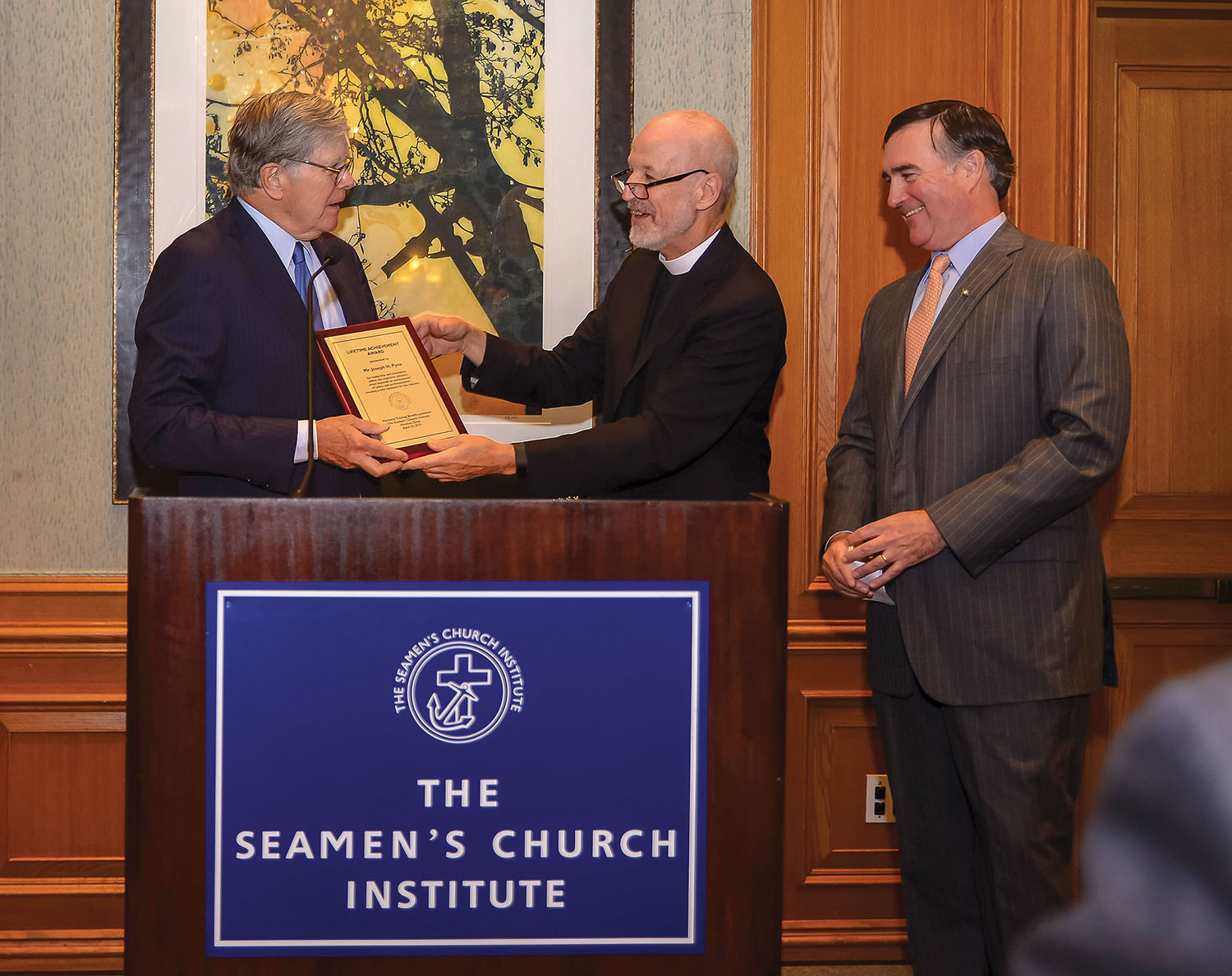 The Rev. David Rider of Seamen’s Church and Christian O’Neil of Kirby Marine Transportation Group present Kirby’s Chairman Joe Pyne with the 2019 Lifetime Achievement Award. (Photo courtesy of Seamen’s Church Institute)