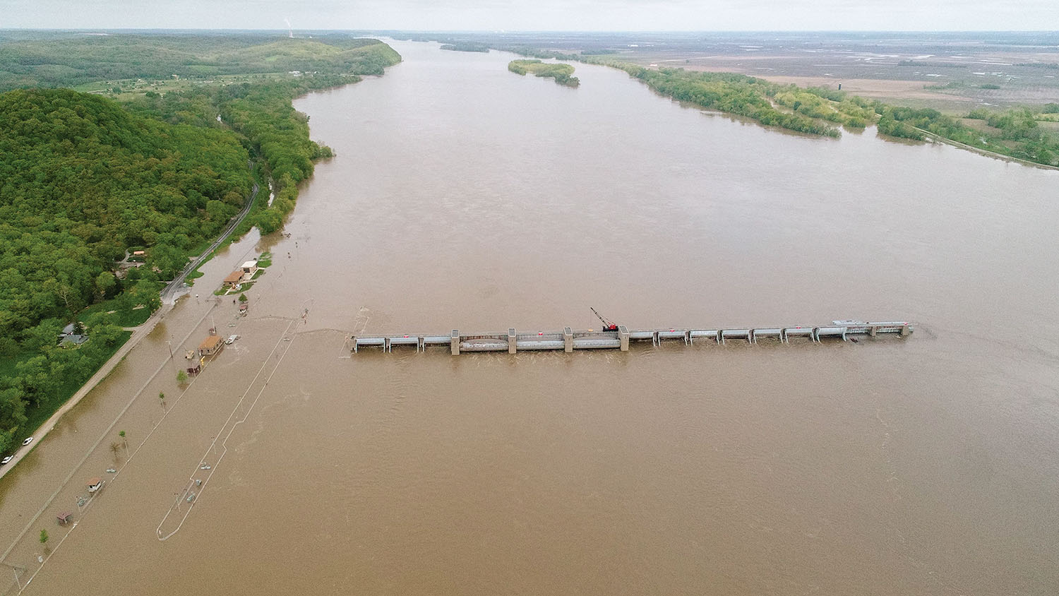 Only the outlines of the lock walls can be seen as Upper Mississippi River Lock and Dam 22 is swamped by floodwater. (Photo courtesy of U.S. Army Corps of Engineers, Rock Island District)