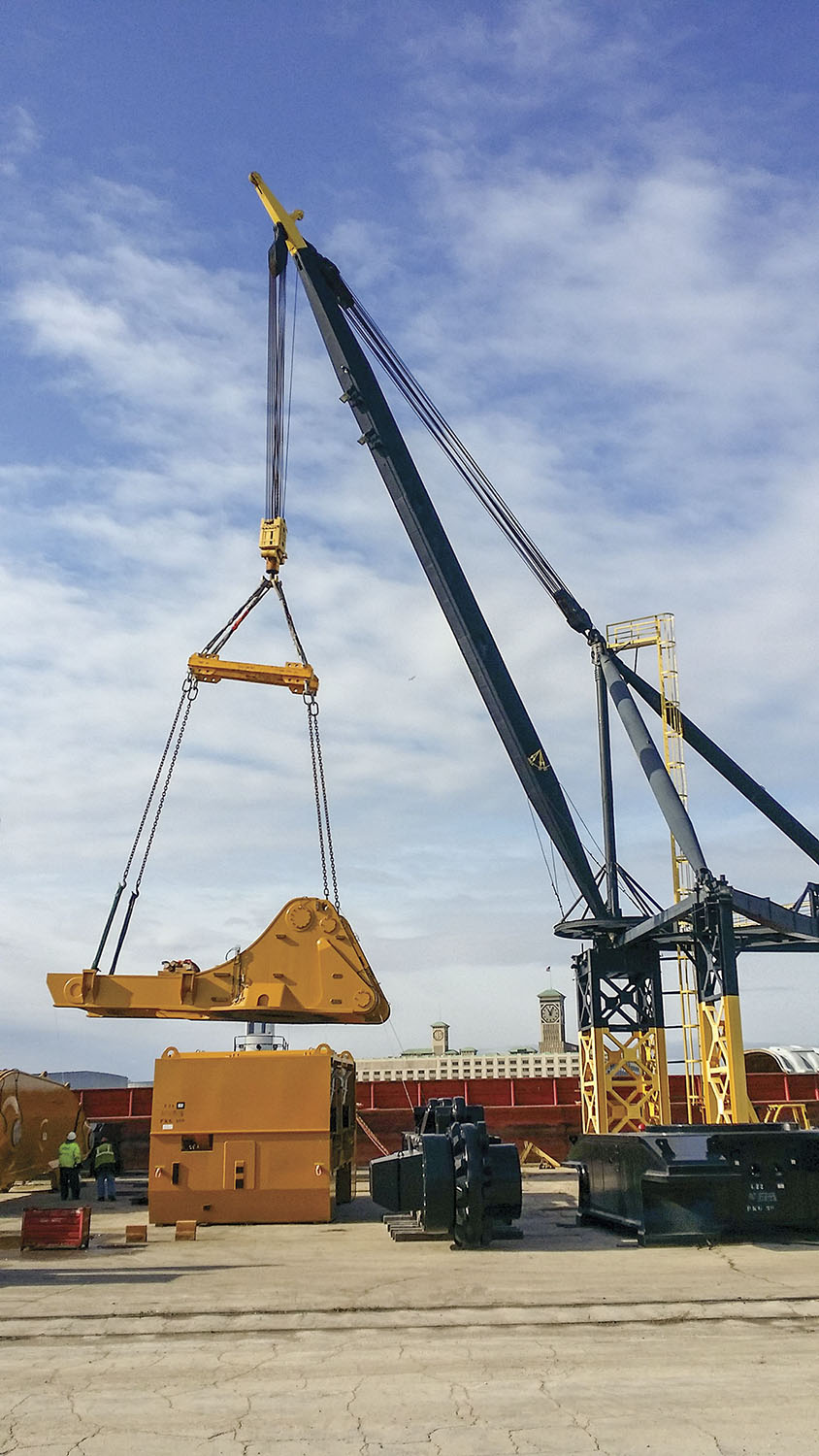 Mining equipment is loaded onto a river barge by Port Milwaukee’s 220 ton Stiff Leg Derrick for transit to Houston via the inland waterway system. Port Milwaukee is one of few Great Lakes ports with access to the Mississippi for tug-and-barge service connectivity to Lake Michigan. (Photo courtesy of Port Milwaukee)