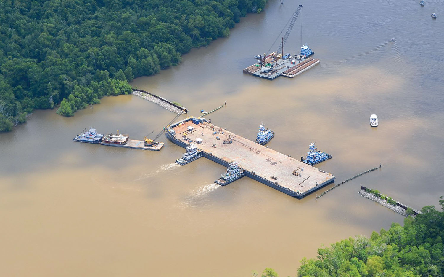 Installation of the ‘barge gate’ across Bayou Chene to prevent backwater flooding, both from the Atchafalaya River and from the potential operation of the Morganza Floodway. (photo courtesy of the Louisiana Civil Air Patrol/St. Mary Parish Office of Emergency Preparedness and Homeland Security)