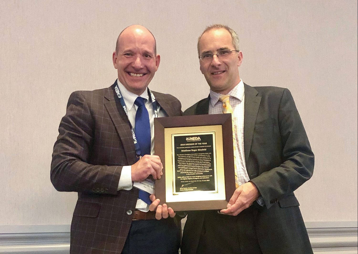 Matt Binsfeld, left, president and CEO of J.F. Brennan Company, receives the 2019 Dredger of the Year award from Marcel Hermans, president and chairman of WEDA, during the WEDA Dredging Summit and Expo.