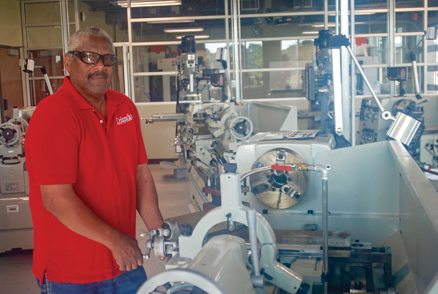 John Guidry and CNC machine. (Photo by Capt. Richard Eberhardt)