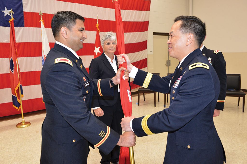 Maj. Gen. Mark Toy (Right), Great Lakes and Ohio River Engineer Division commander, passes the Corps of Engineers flag to Lt. Col. Sonny B. Avichal as Avichal took command of the Nashville District during a change of command ceremony June 28 at the Tennessee National Guard Armory in Nashville, Tenn.( Corps photo by Mark Rankin)