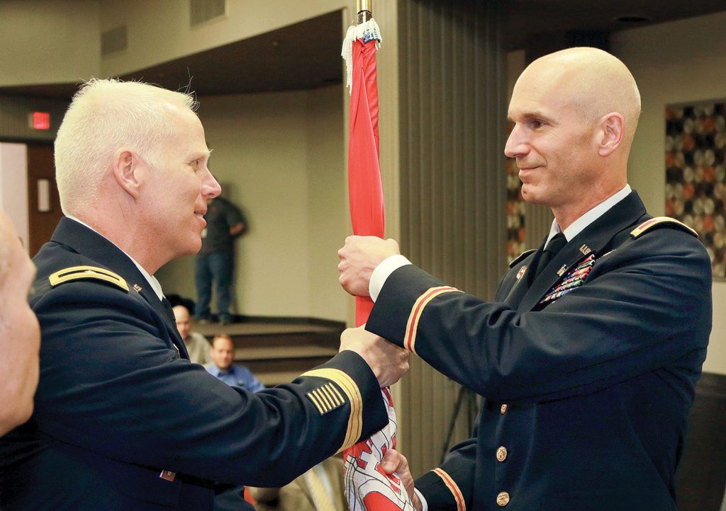 Brigadier Gen. Paul Owen, Southwestern Engineer Division Commander, presents the Corps of Engineers flag to Col. Scott Preston during a change of command ceremony at the Tulsa Engineer District July 8. (Corps photo by Daren Reehl)