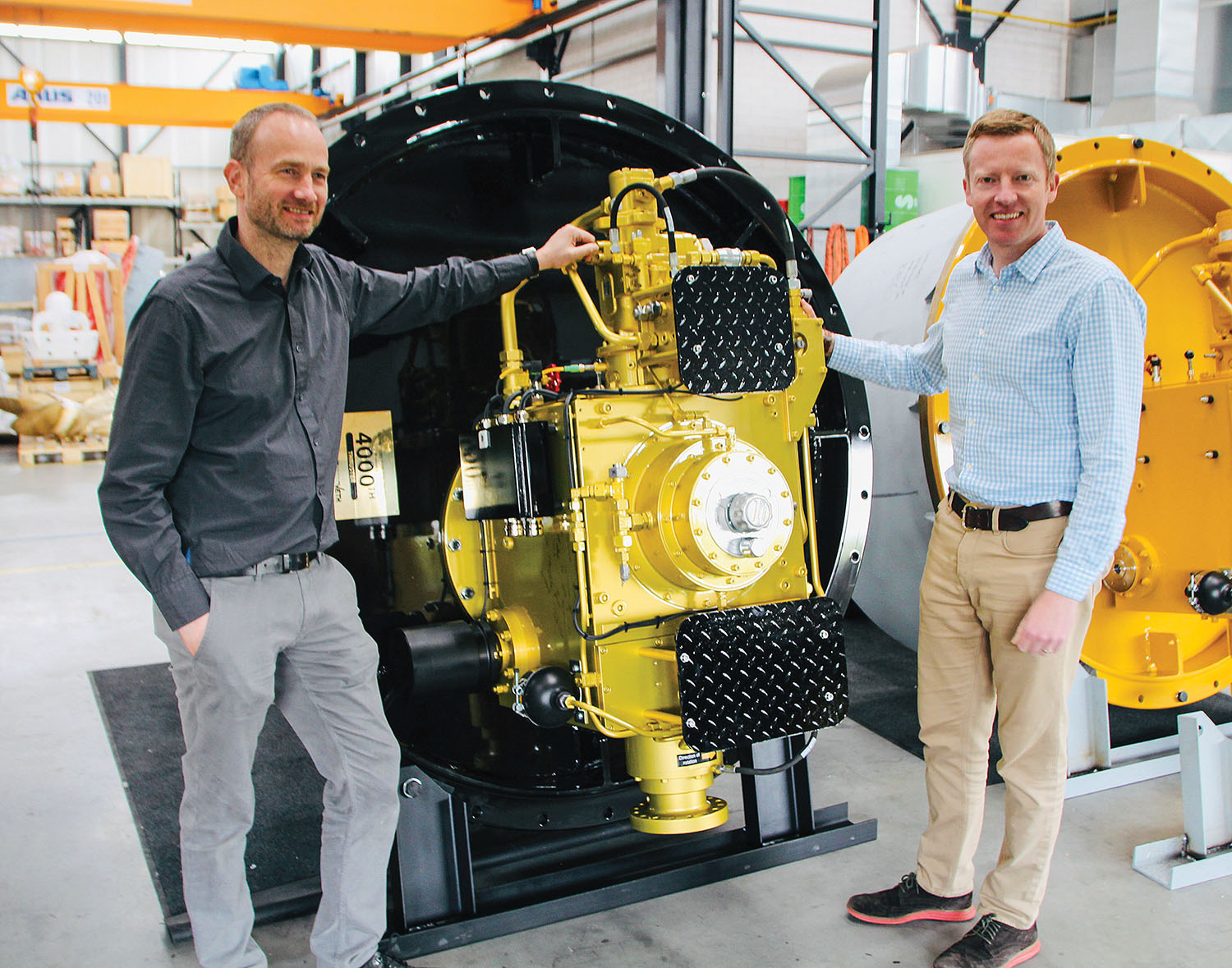 Erik Veth (left) and Tim Batten traveled to Greece to deliver a special-edition, golden thruster, the 4,000th thruster produced by Veth Propulsion since the first was built in 1986.