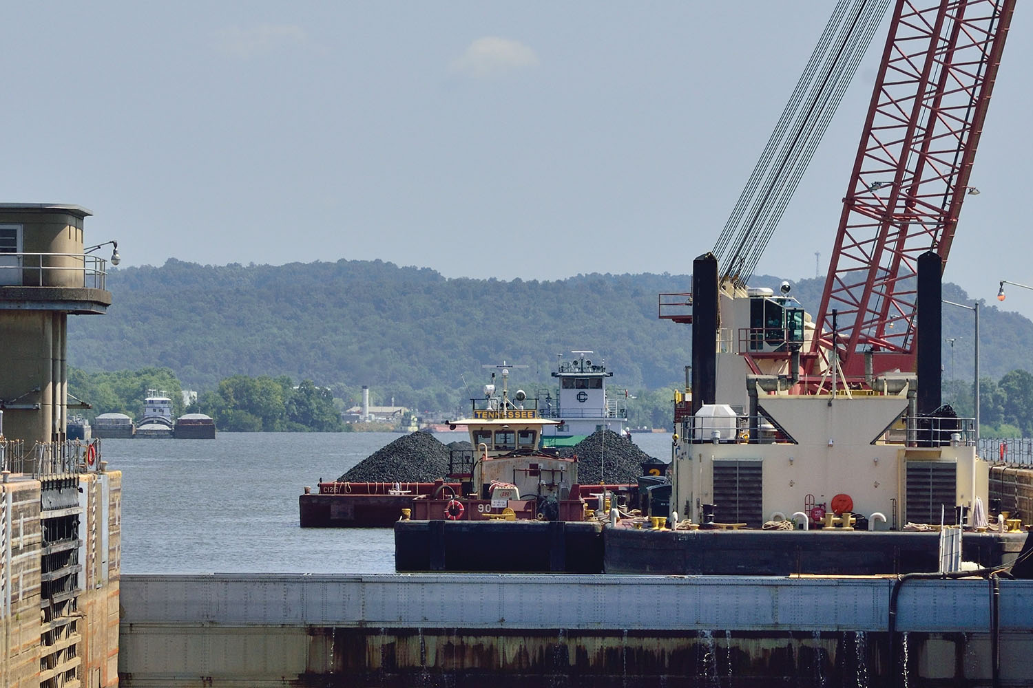 A Crounse Corporation boat has tied off its tow at the upper approach of the Willow Island Locks and Dam as it prepares to assist upbound boats through the auxiliary chamber during repairs to the main lock. (Photo by Jim Ross)