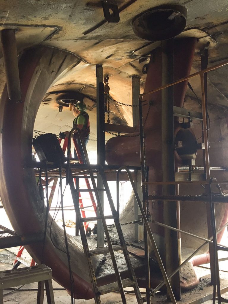 A worker installs a new strut leg for one of the three rudders on the mv. Robert L. Posey. (Photo courtesy of ACBL)