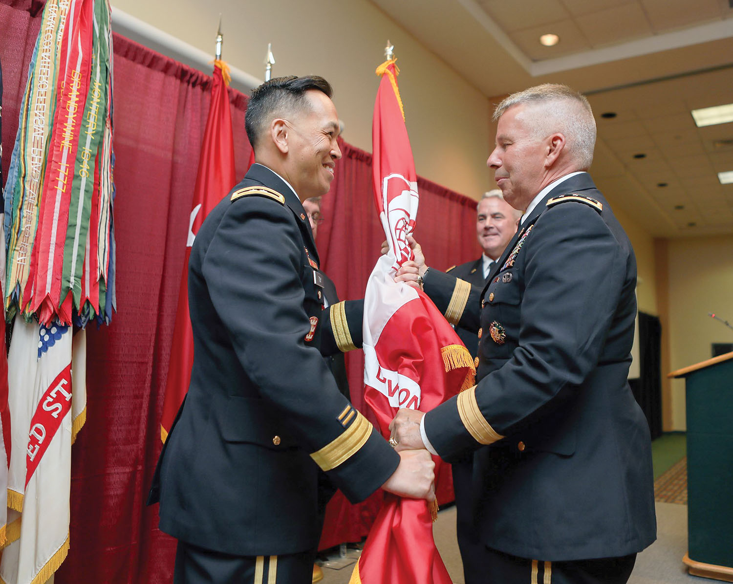 Lt. Gen. Todd Semonite, chief of engineers and commanding general of the U.S. Army Corps of Engineers, right, hands the division flag to Maj. Gen. Mark Toy. (U.S. Army Corps of Engineers photo)