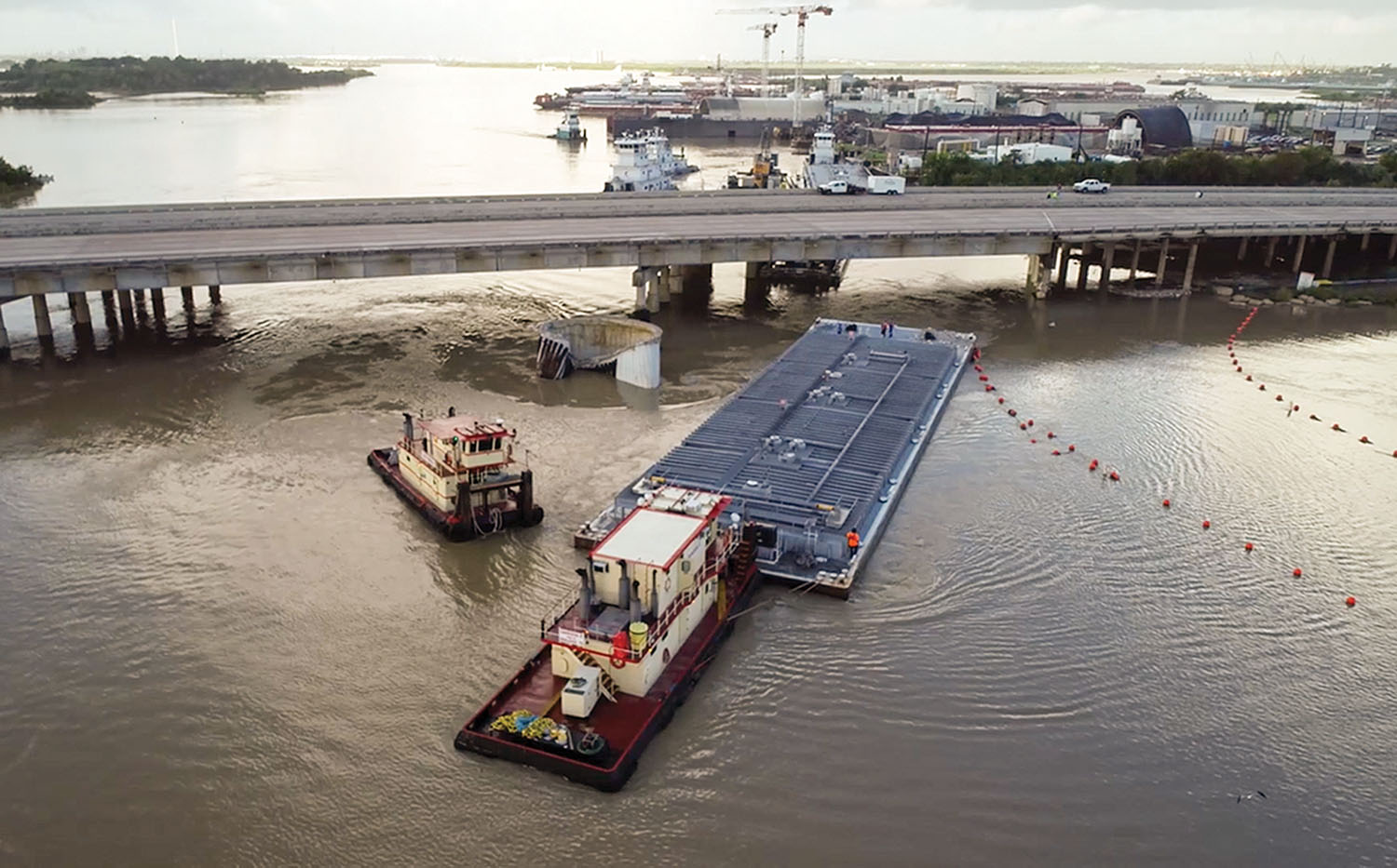 Screen capture from Coast Guard drone video of the removal of the second barge from the I-10 bridge.