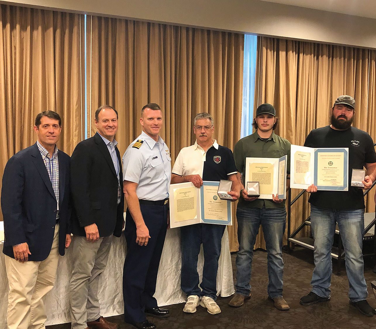 Coast Guard award presentation, from left: David Lane, Canal Barge senior vice president-marketing; Merritt Lane, president and CEO; Coast Guard Capt. Capt. Lewin; Stephan Hill, chief engineer; Dylan Littlejohn, lead deckhand; and Adam ‘Gator’ Dobbs, pilot. (Photo courtesy of Canal Barge Company)