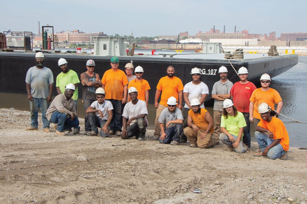 Matt Thomas (without hard hat) amid shipyard workers of Eagle Fabrication. (Photo by Nelson Spencer Jr.)