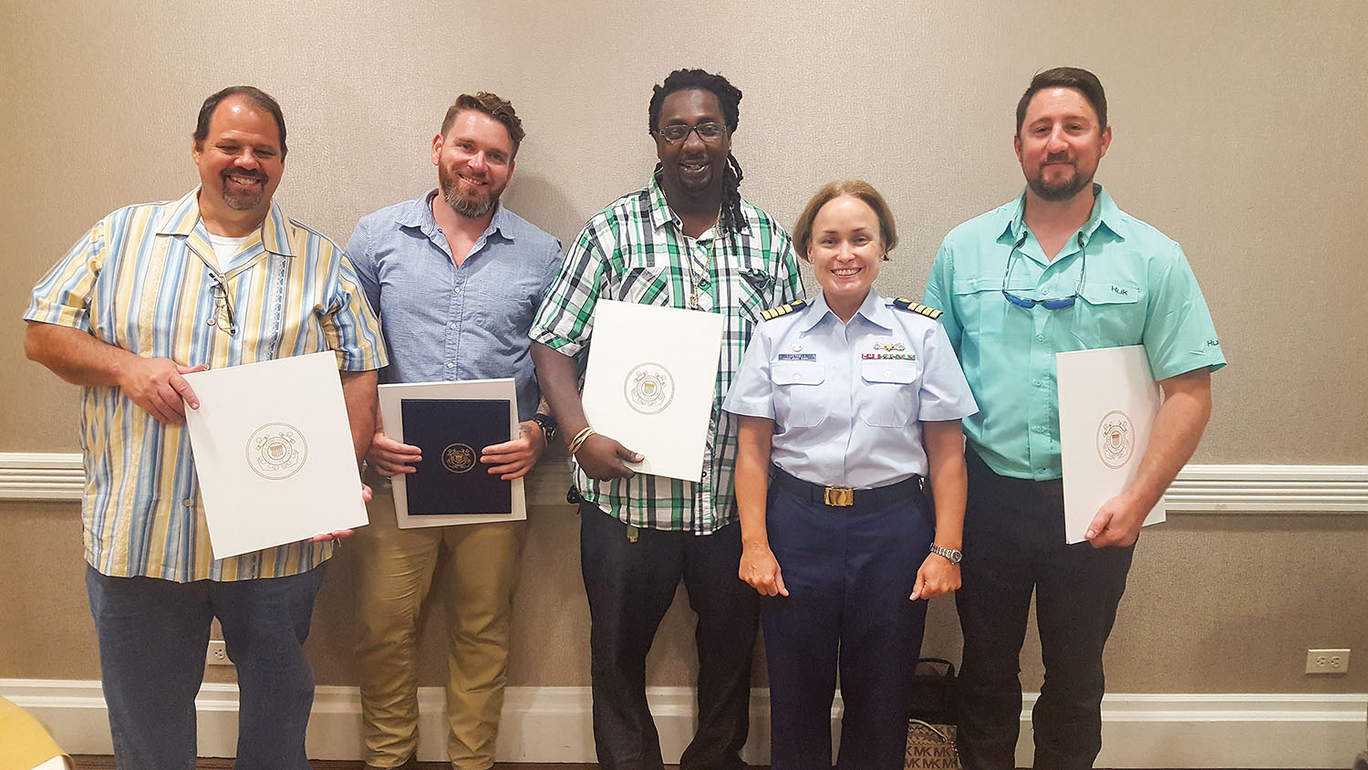 Coast Guard Capt. Kristi Luttrell presented a Certificate of Merit to the crew of the Z-drive ship assist  tug Archie T. Higgins for assisting the Creole Queen when it lost power with 273 passengers on board. From left: mate Eric Burlette, Capt. Josh Sheffield, deckhand Jacob Toliver, Luttrell and engineer Ryan Harrison. (Photo by Capt. Richard Eberhardt)