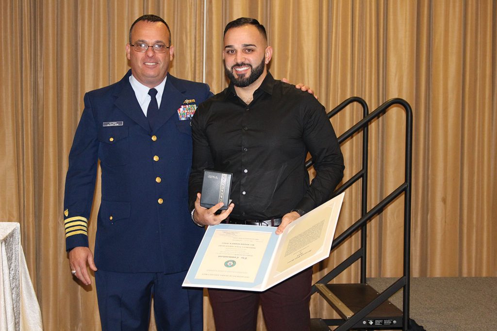 Coast Guard Capt. Dittman presents award to mate Chad Perez. (Photo courtesy of Canal Barge Company)