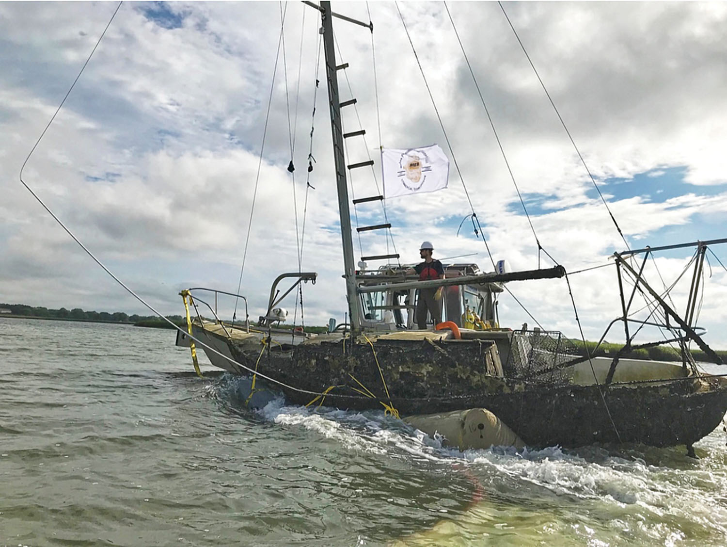 MER Commercial Diving crew members utilize lift bags for the removal of a sailboat in the Folly River in Folly Beach, S.C.