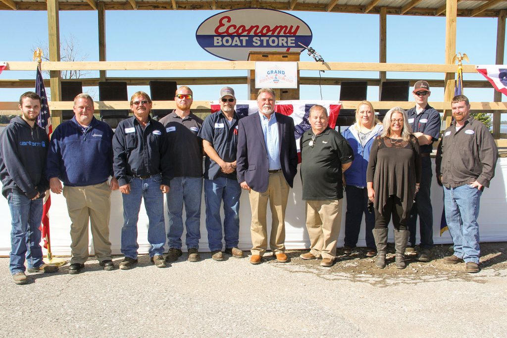 Economy Boat Store employees pause for a moment after the reopening and dedication ceremony. (Photo by Nelson Spencer Jr.)