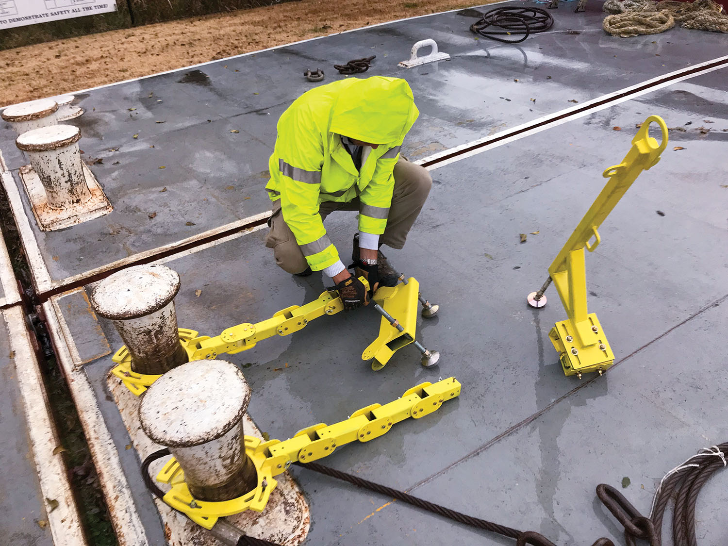 Dan Walsh of G&C Multi-Services quickly assembles the positioner on the AOI handrail system. (Photo by Clint Conway/G&C Multi-Services)