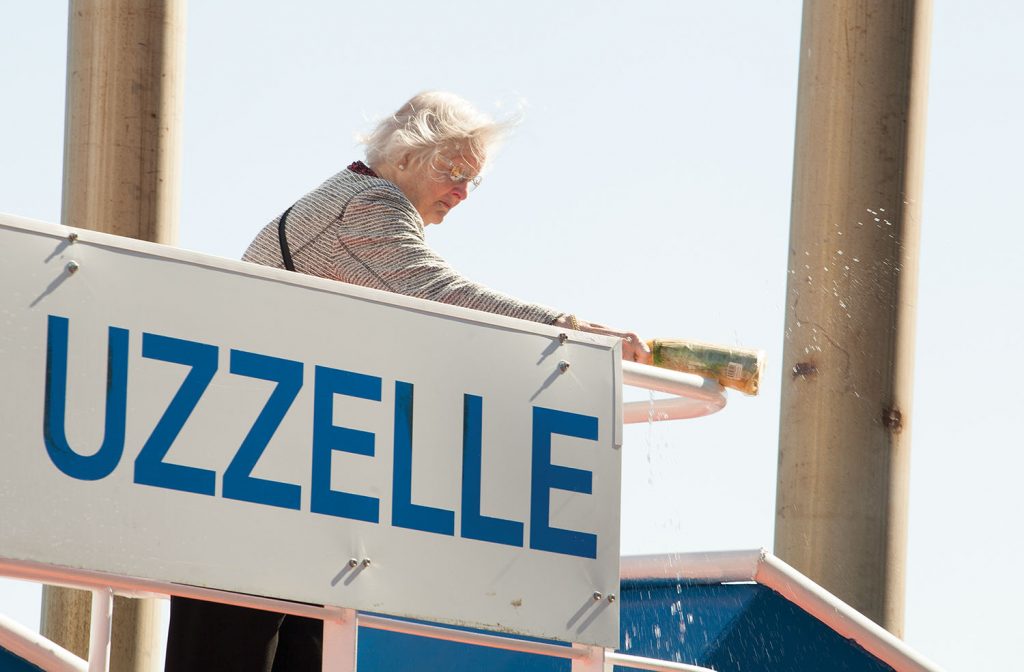 Kathie Uzzelle, wife of the late Hamp Uzzelle, christens the Parker Towing vessel named for her husband. (Photo by Frank McCormack)