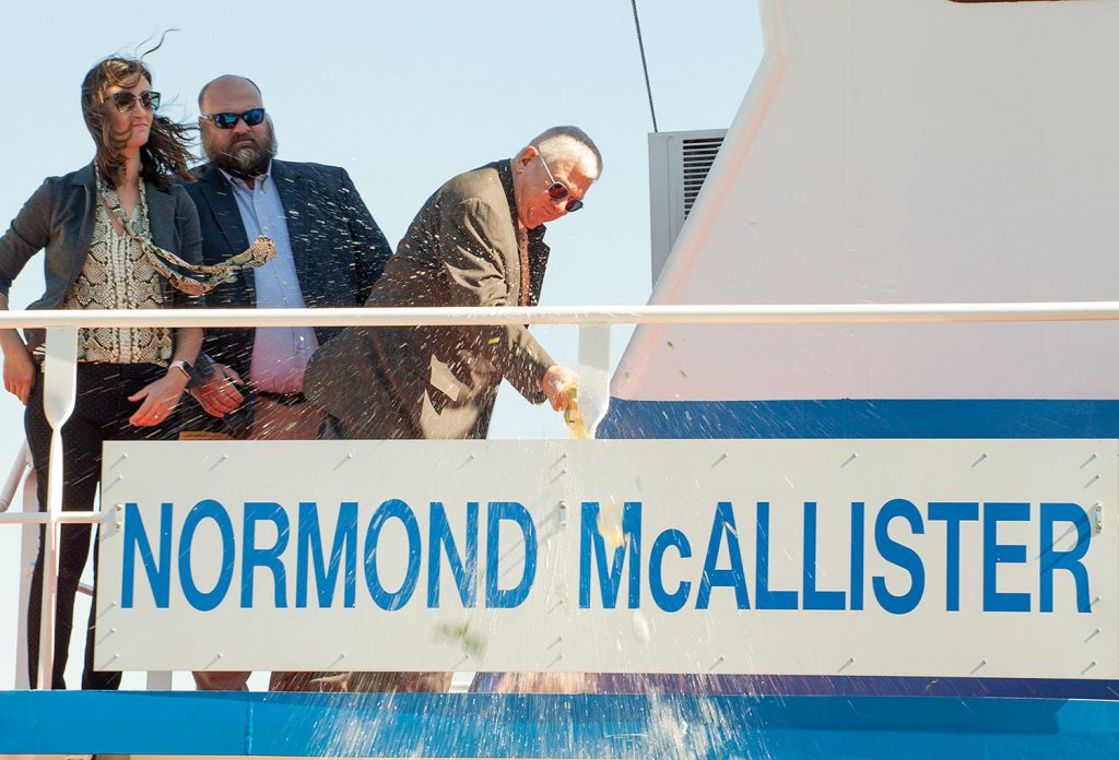 Normond McAllister christens his namesake vessel. Also pictured are Alison Phillips, recruitment manager and director of communications for Parker Towing, and Chas Haun, executive vice president. (Photo by Frank McCormack)