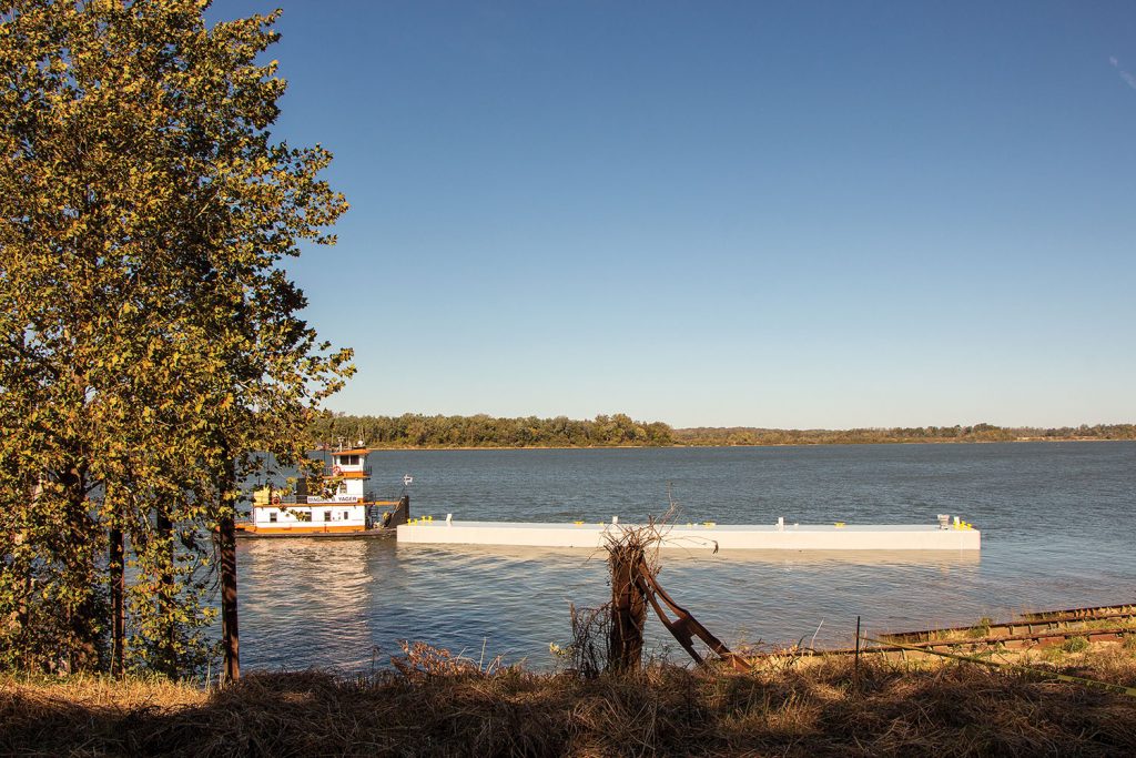 The mv. Maggie B. Yager collects the new barge following launch. (Photo by Jason Koenig)