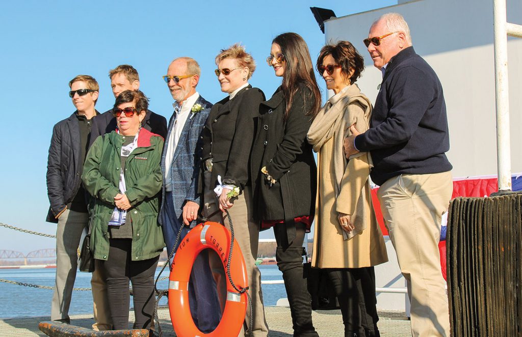 Tom Torretti (fourth from left in blue jacket) and his family pause for a quick photo on board his namesake vessel. (Photo by Shelley Byrne)