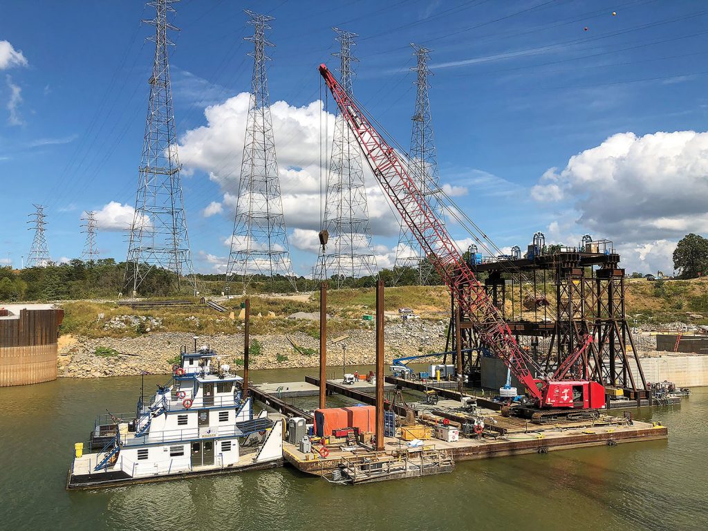 The Nashville Engineer District and its contractor partner Johnson Brothers near completion in setting a 1.3-million-pound concrete shell September 23, 2019, on the riverbed on the downstream end of Kentucky Lock, where it will be part of a cofferdam and eventually a permanent part of the new lock wall. It was the eighth of 10 shells that are being placed. (Photo by Barney Schulte)