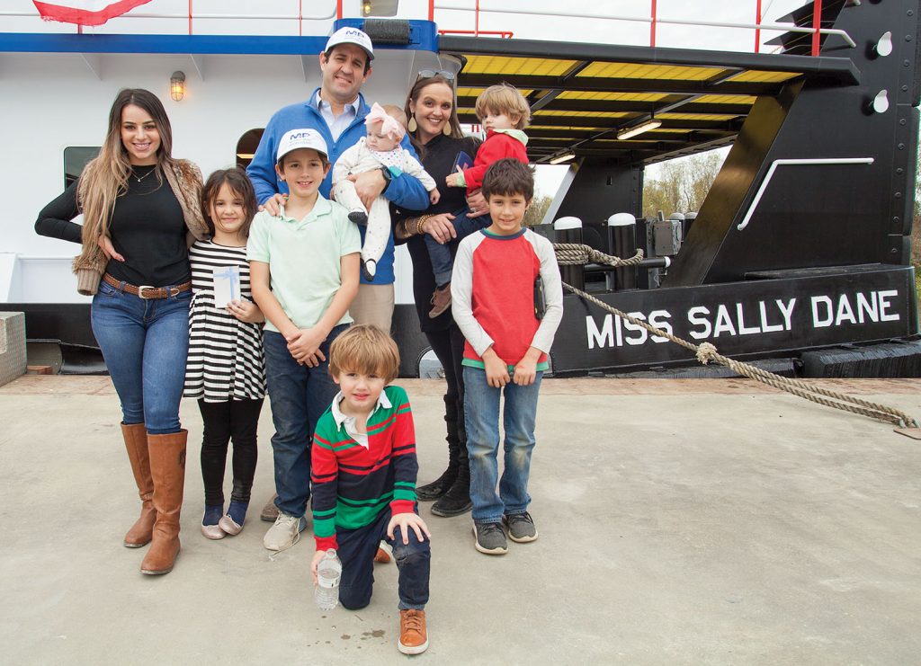 Austin and Sally Sperry stand before the mv. Miss Sally Dane December 20, following the christening ceremony for the Maritime Partners vessel. Pictured also are their children Kenison (with Austin), Henry (with Sally), Genevieve, Jack and John Austin (front middle), along with cousin Grayson (front right) and Maddy, the children’s nanny. (Photo by Frank McCormack)