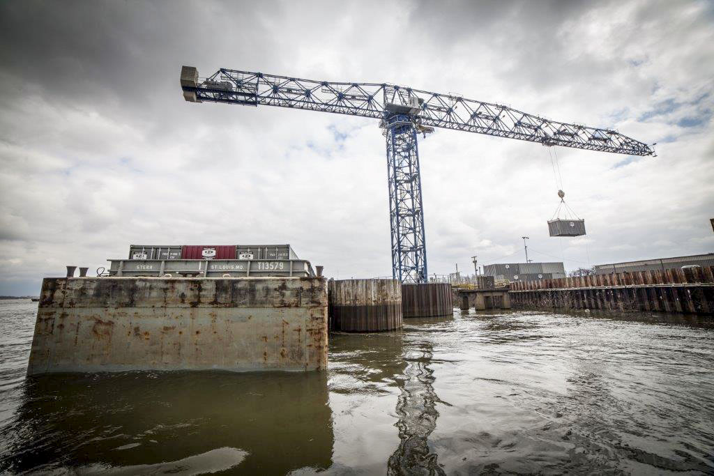 A crane lifts a container into a barge at the Paducah Riverport. A recent marine highways grant the port received is for the purchase or lease of equipment as an initial step toward beginning regularly scheduled container on barge service between Paducah and Baton Rouge, La. (Photo courtesy of Paducah-McCracken County Riverport Authority)