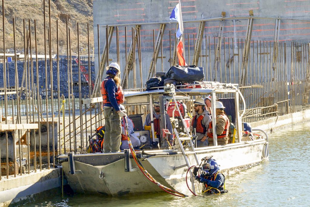 A diver enters the water to assist with the placement of the shell. (Corps of Engineers photo by Mark Rankin)